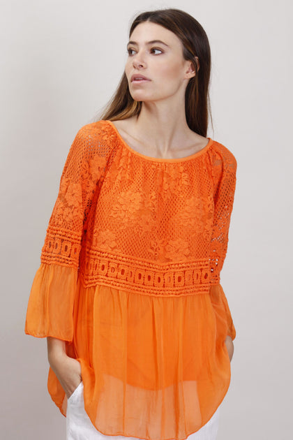Orange silk blouse with lace neck trim